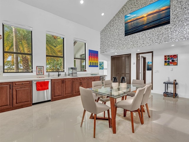 dining room with recessed lighting and high vaulted ceiling
