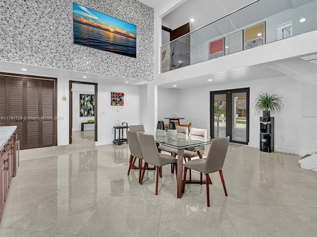 dining room featuring a high ceiling, french doors, marble finish floor, recessed lighting, and baseboards