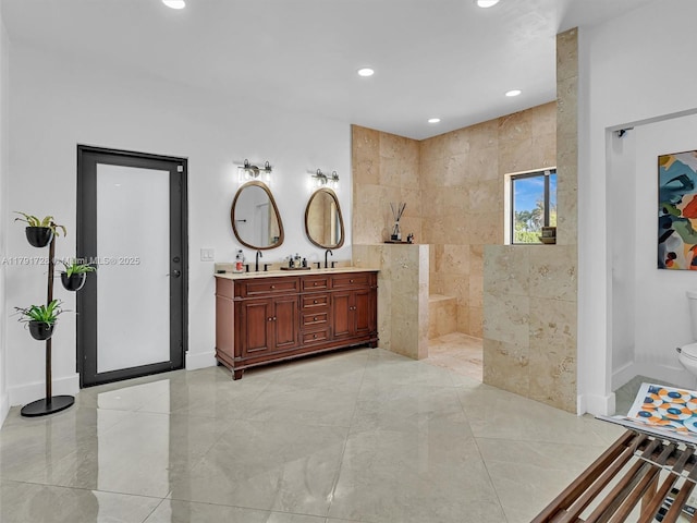full bathroom featuring walk in shower, a sink, double vanity, recessed lighting, and baseboards