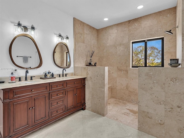 full bath with double vanity, a walk in shower, and a sink