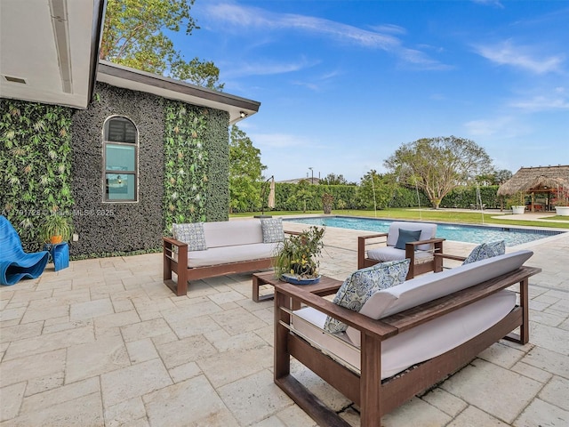 view of patio with outdoor lounge area and an outdoor pool