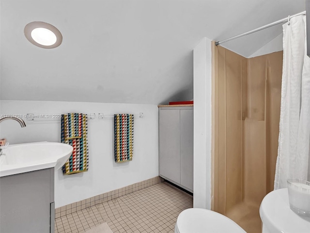bathroom featuring vanity, a shower stall, vaulted ceiling, and toilet