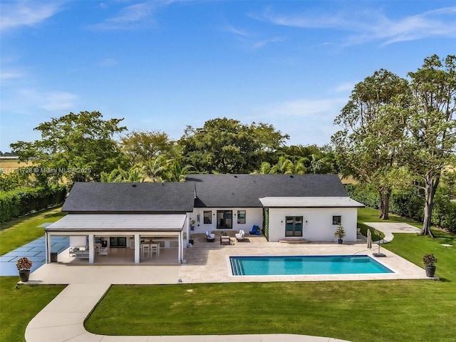 rear view of house featuring french doors, an outdoor pool, a patio area, a yard, and outdoor lounge area