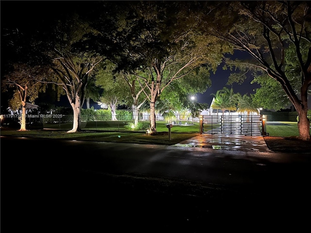 view of home's community featuring fence