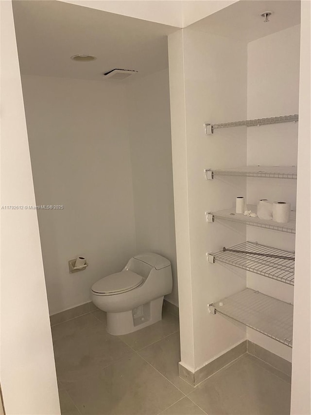 14951 Royal Oaks Ln Unit 806, North Miami, FL 33181 - bathroom featuring toilet, baseboards, and tile patterned flooring