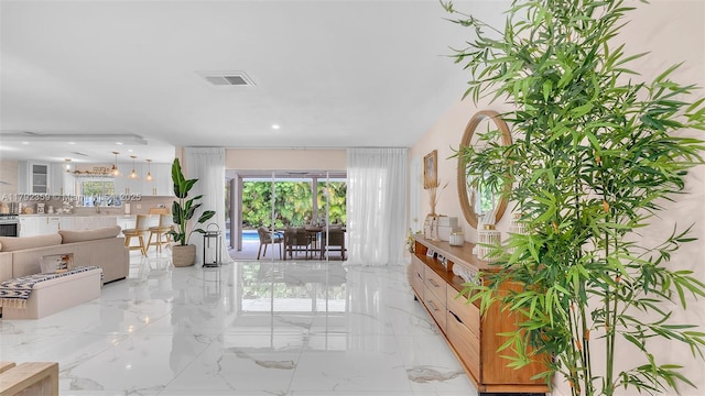 living room featuring visible vents and marble finish floor