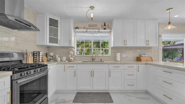 kitchen with marble finish floor, a sink, wall chimney exhaust hood, and stainless steel gas stove