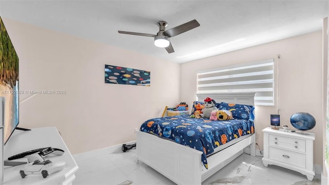 bedroom with baseboards, ceiling fan, and marble finish floor