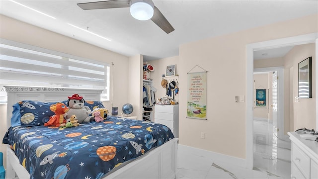 bedroom featuring baseboards, ceiling fan, and marble finish floor