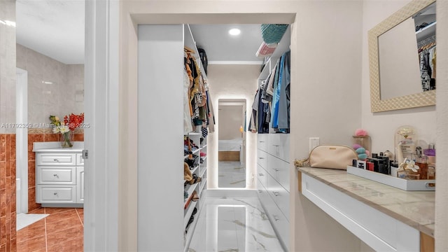spacious closet with marble finish floor