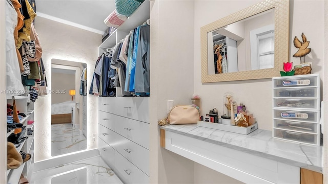 spacious closet with marble finish floor