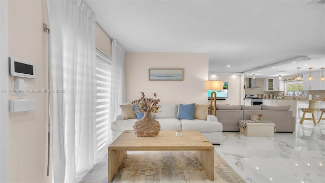 living room with recessed lighting and marble finish floor