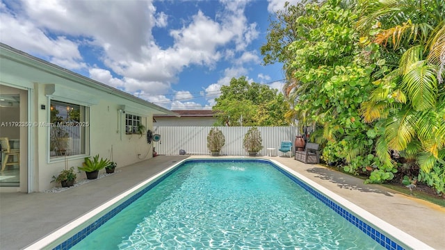 view of swimming pool with a fenced in pool and fence