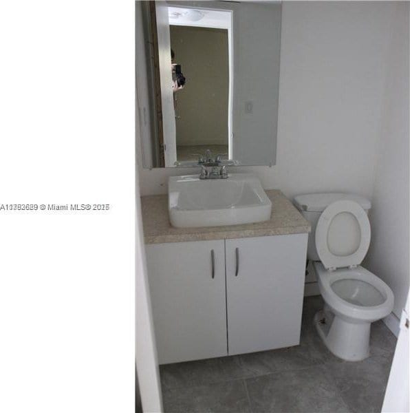 11905 NE 2nd Ave Unit C206, North Miami, FL 33161 - half bath with toilet, tile patterned floors, and vanity