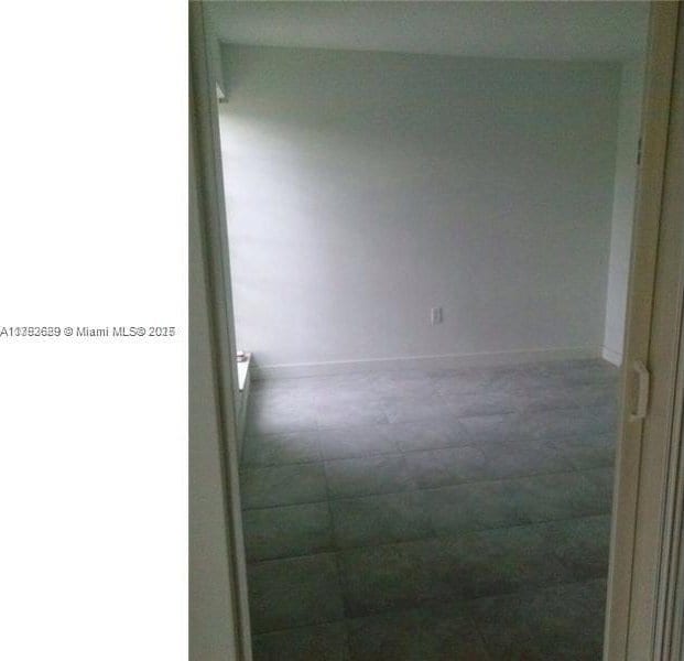 11905 NE 2nd Ave Unit C206, North Miami, FL 33161 - empty room featuring baseboards