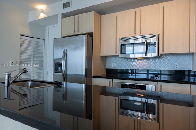 79 SW 12th St Unit 1403-S, Miami, FL 33130 - kitchen with visible vents, decorative backsplash, dark countertops, and stainless steel appliances