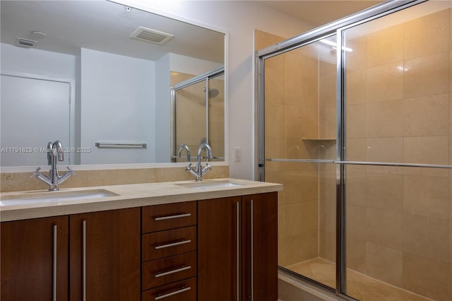 79 SW 12th St Unit 1403-S, Miami, FL 33130 - bathroom featuring double vanity, visible vents, a sink, and a stall shower