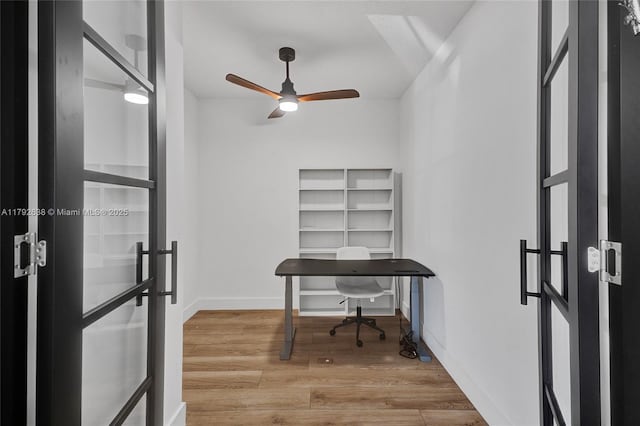 office with french doors, ceiling fan, baseboards, and wood finished floors