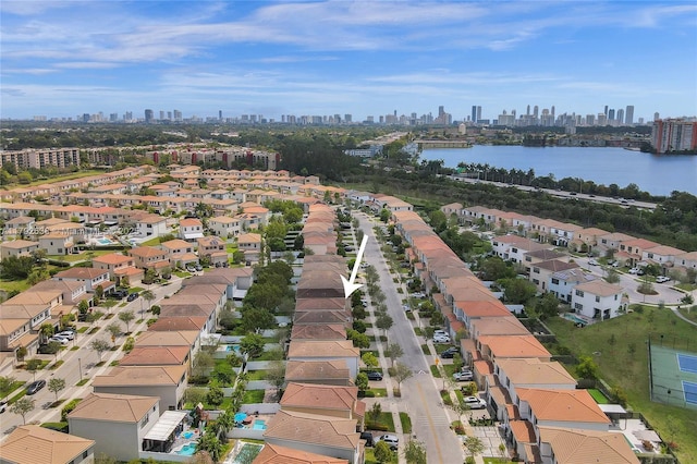 drone / aerial view featuring a view of city and a water view