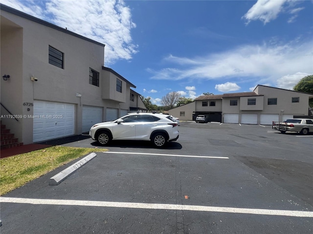 uncovered parking lot featuring a residential view