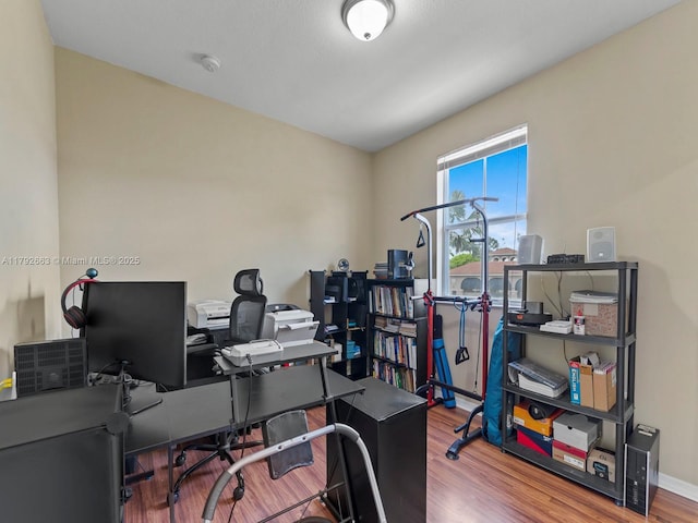 office with baseboards and wood finished floors