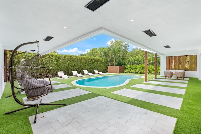view of swimming pool with a fenced in pool, a lawn, and a patio area