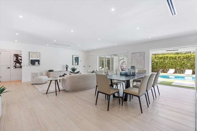 dining room with light wood-type flooring, recessed lighting, and visible vents