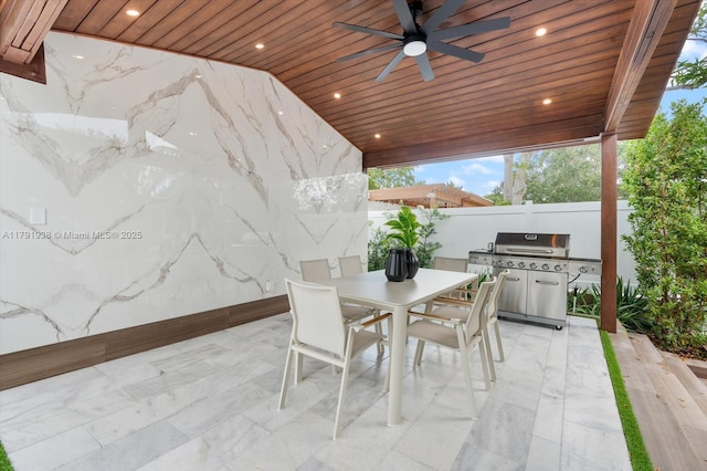 view of patio featuring ceiling fan, fence, outdoor dining space, and a grill