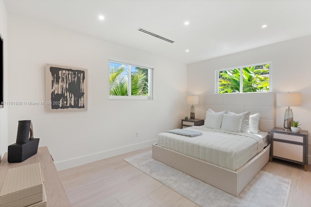 bedroom with multiple windows, recessed lighting, and visible vents