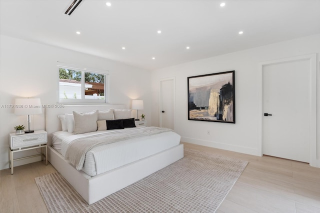 bedroom featuring light wood-type flooring, recessed lighting, and baseboards