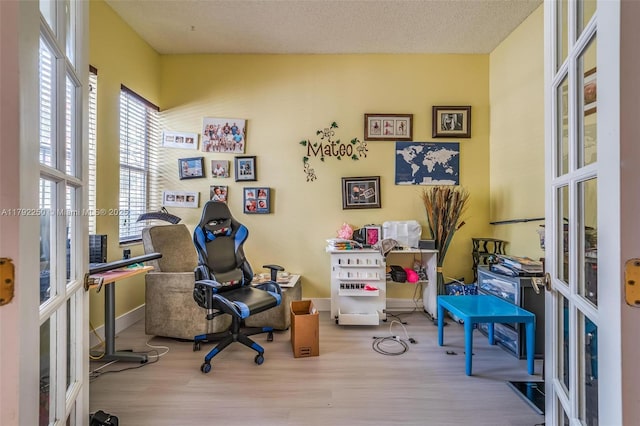 office with baseboards and wood finished floors