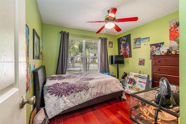 bedroom featuring a textured ceiling, ceiling fan, and wood finished floors