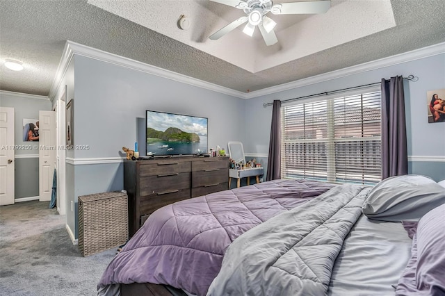 carpeted bedroom featuring ornamental molding, a ceiling fan, and a textured ceiling