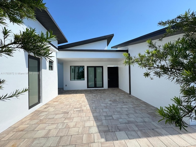 exterior space featuring french doors and stucco siding