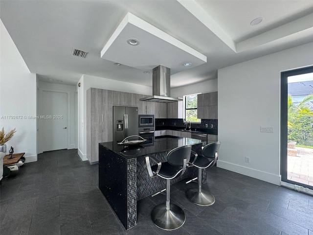kitchen featuring visible vents, island range hood, dark countertops, modern cabinets, and stainless steel appliances