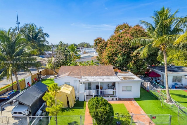 9000 NW 25th Ave, Miami, FL 33147 - rear view of property featuring a gate, a fenced front yard, stucco siding, and a yard