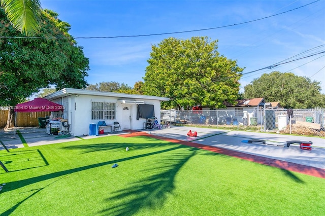 9000 NW 25th Ave, Miami, FL 33147 - exterior space with fence, stucco siding, and a yard