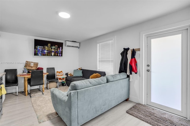 9000 NW 25th Ave, Miami, FL 33147 - living room with light wood-style floors and a wall mounted air conditioner