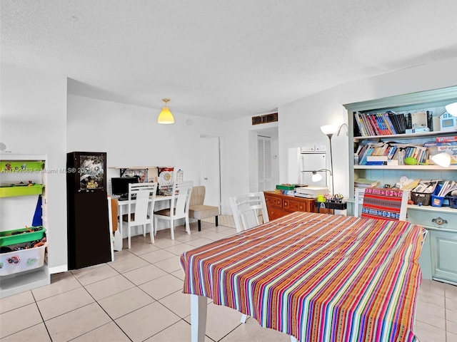 1780 NE 191st St Unit 205-2, Miami, FL 33179 - bedroom featuring visible vents, a textured ceiling, and light tile patterned flooring