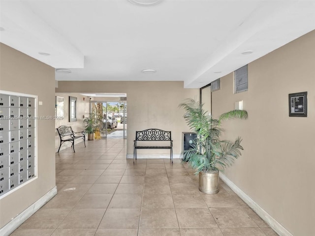 1780 NE 191st St Unit 205-2, Miami, FL 33179 - corridor featuring baseboards, mail area, and light tile patterned floors