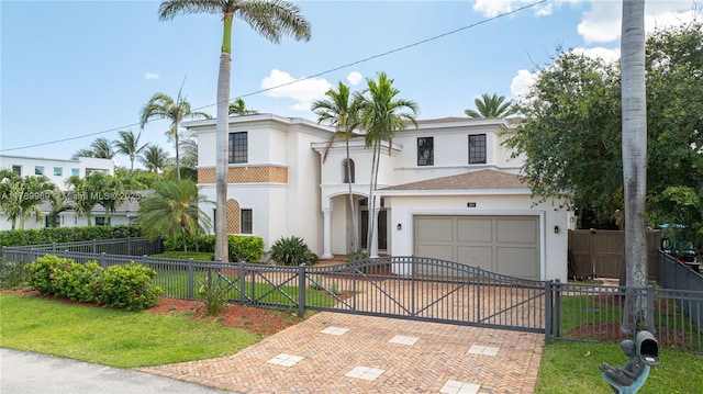 260 NE Wavecrest Ct, Boca Raton, FL 33432 - mediterranean / spanish-style home with a fenced front yard, a gate, decorative driveway, a front lawn, and stucco siding
