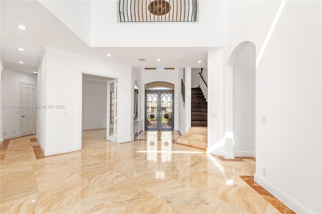 260 NE Wavecrest Ct, Boca Raton, FL 33432 - foyer entrance featuring french doors, visible vents, arched walkways, marble finish floor, and recessed lighting