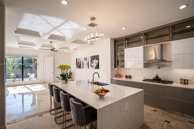 260 NE Wavecrest Ct, Boca Raton, FL 33432 - kitchen featuring wall chimney exhaust hood, modern cabinets, stainless steel gas cooktop, decorative backsplash, and recessed lighting