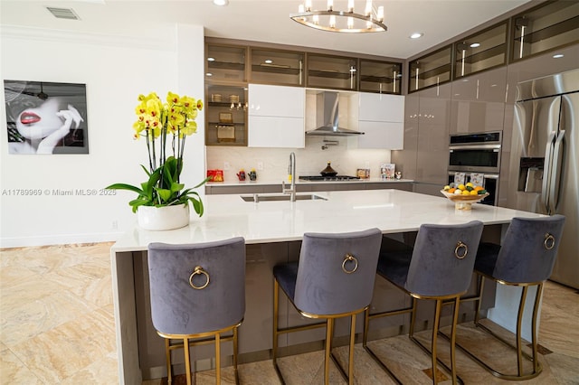 260 NE Wavecrest Ct, Boca Raton, FL 33432 - kitchen featuring appliances with stainless steel finishes, wall chimney range hood, modern cabinets, backsplash, and glass insert cabinets