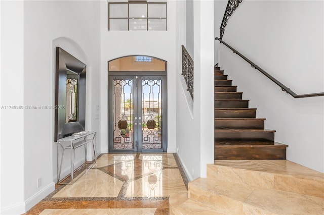 260 NE Wavecrest Ct, Boca Raton, FL 33432 - entryway with baseboards, french doors, marble finish floor, and a towering ceiling