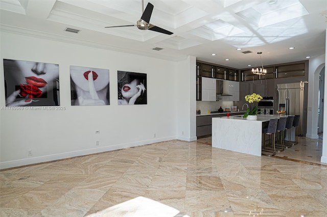 260 NE Wavecrest Ct, Boca Raton, FL 33432 - kitchen with stainless steel fridge, coffered ceiling, a chandelier, decorative light fixtures, and arched walkways