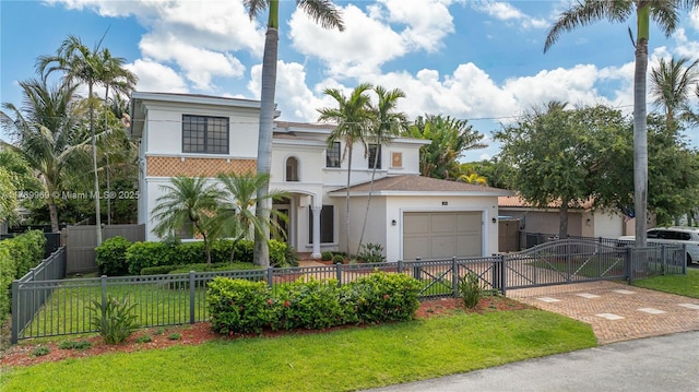 260 NE Wavecrest Ct, Boca Raton, FL 33432 - view of front of home featuring an attached garage, stucco siding, driveway, a gate, and a fenced front yard