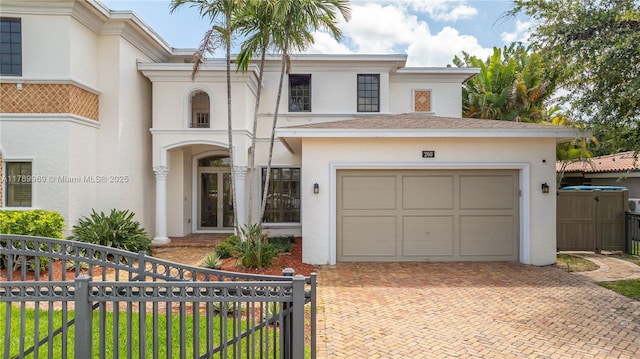 260 NE Wavecrest Ct, Boca Raton, FL 33432 - view of front of house with stucco siding, decorative driveway, an attached garage, and a gate