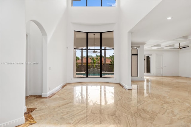 260 NE Wavecrest Ct, Boca Raton, FL 33432 - spare room with a ceiling fan, marble tiled floors, a high ceiling, arched walkways, and recessed lighting