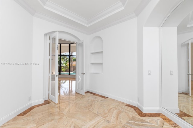 260 NE Wavecrest Ct, Boca Raton, FL 33432 - spare room with built in features, ornamental molding, light marble finish flooring, arched walkways, and a raised ceiling